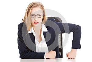 Attractive business woman by the table, bossy behaviour.