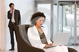 Attractive business woman working on laptop