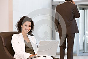 Attractive business woman working on laptop