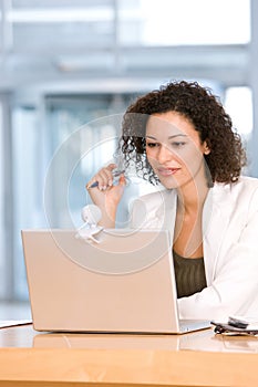 Attractive business woman working on laptop