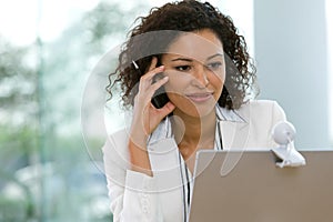 Attractive business woman working on laptop