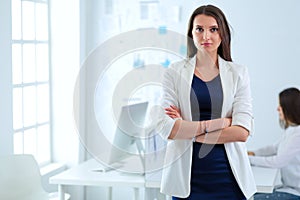 Attractive business woman working on laptop at office. Business people