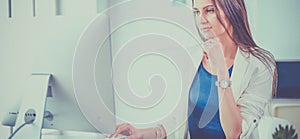 Attractive business woman working on laptop at office. Business people