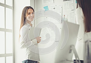 Attractive business woman working on laptop at office. Business people