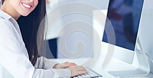 Attractive business woman working on laptop at office. Business people