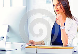 Attractive business woman working on laptop at office. Business people