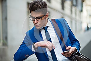 Attractive businessman checking the time