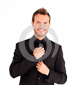 Attractive businessman corrects a tie