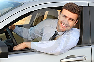 Attractive businessman driving a car