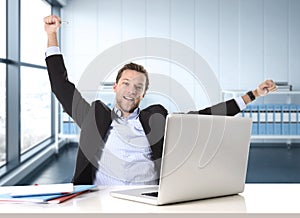 Attractive businessman happy and hectic at office work sitting at computer desk satisfied celebrating