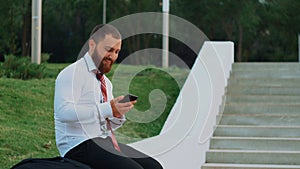 Attractive businessman looking at a mobile phone, feeling happy and leaving