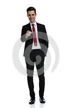 Attractive businessman pointing forward