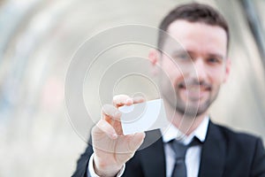 Attractive businessman showing an empty textspace card photo