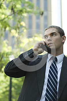 Attractive Businessman Using Cell Phone Outside