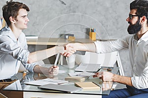 Attractive businessmen shaking hands