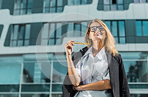 Attractive Businesswoman before Building