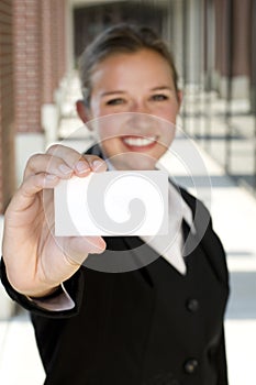 Attractive businesswoman holding a card