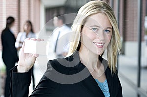 Attractive businesswoman holding a card