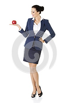 Attractive businesswoman holding red apple