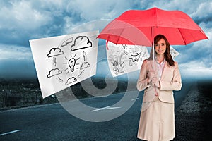 Attractive businesswoman holding red umbrella