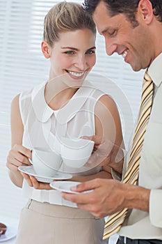 Attractive businesswoman laughing with her colleague