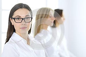 Attractive businesswoman at meeting or conference against the background of colleagues. Group of business people at work