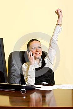 Attractive businesswoman on the phone winning