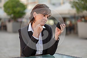 Attractive businesswoman reading a text message