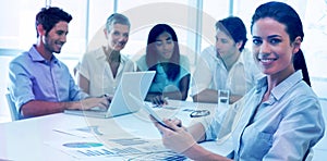 Attractive businesswoman smiling in business meeting