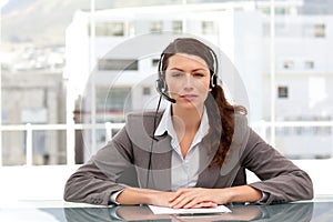 Attractive businesswoman speaking using headset