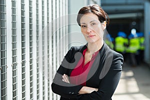 Attractive businesswoman standing with armcrossed