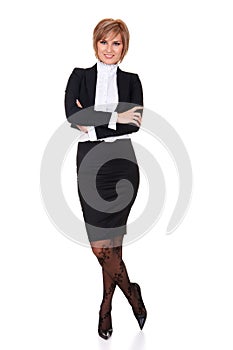 Attractive businesswoman standing and posing. Full length portrait with arms crossed