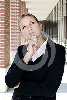 Attractive businesswoman in thoughtful pose