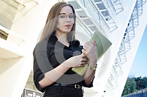 Attractive businesswoman wearing glasses holding a folder