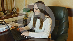 Attractive businesswoman working late at night on laptop