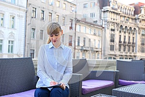 Attractive businesswoman working in a restaurant terrace