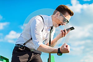 Attractive busunessman in white shirt, tie, braces and sunglasse