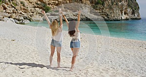 Attractive carefree young women, excited on holiday beach getaway, laughing and enjoying fun outside in the summer