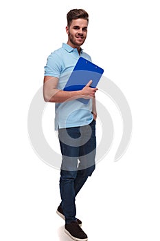 Attractive casual man wearing blue polo short holds blue files