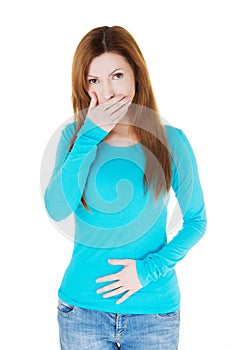 Attractive casual woman with hand on mouth and belly.