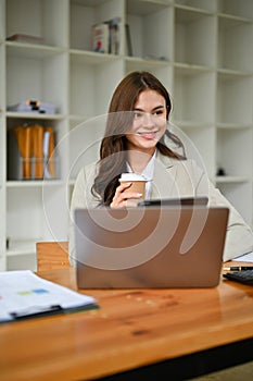 Attractive caucasian businesswoman in business suit is in the meeting with her team