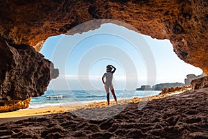 Attractive Caucasian female in the natural cave in the Algarve at Praia da Coelha, Albufeira