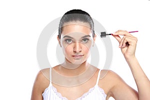 Attractive caucasian model using eyebrows comb