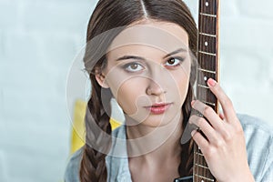 attractive caucasian teen girl with electric guitar