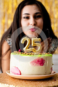 Attractive caucasian woman in black party dress ready to eat birthday cake