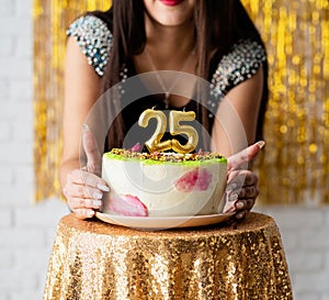 Attractive caucasian woman in black party dress ready to eat birthday cake