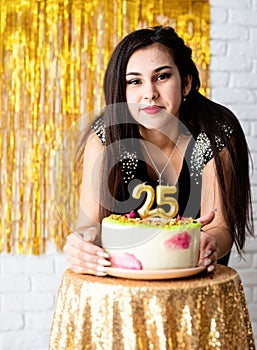Attractive caucasian woman in black party dress ready to eat birthday cake