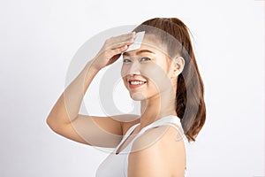 Attractive Charming Asian young woman smile and using tissue with toner for cleaning make up feeling so fresh and clean