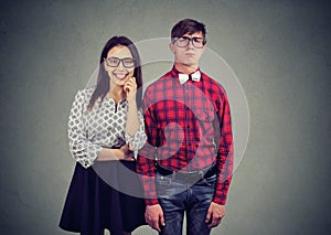 Attractive charming woman dating with nerd in old fashioned eyewear and eccentric wear