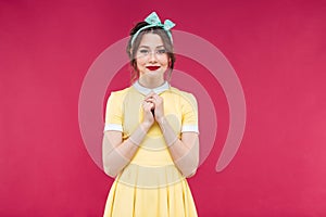 Attractive charming young woman in yellow dress standing